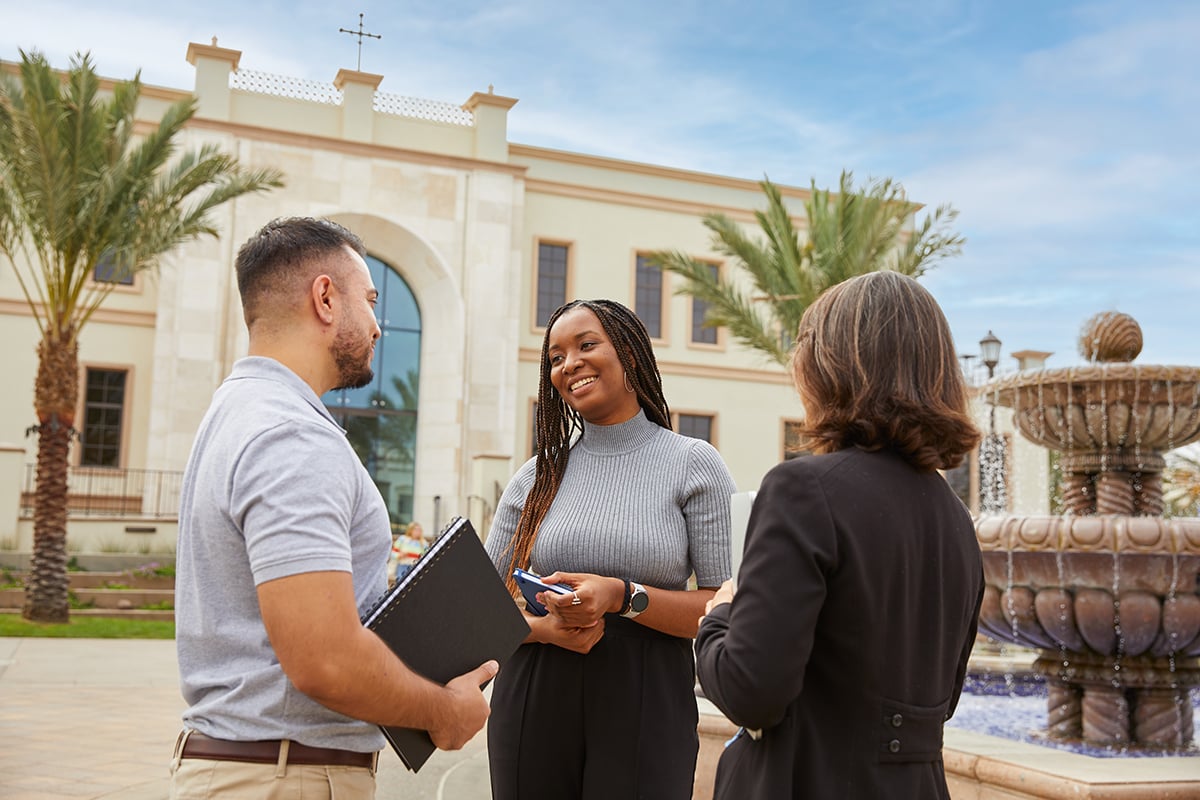 Three MBA students talk outside the Knauss School of Business Three MBA students talk outside the Knauss School of Business